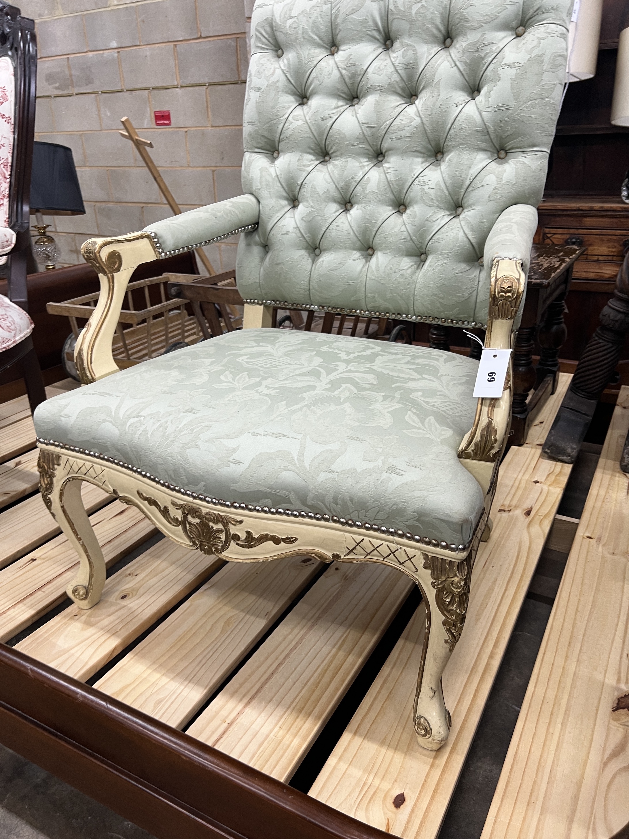 A Louis XVI style painted parcel gilt open armchair with buttoned green upholstery, width 72cm, depth 58cm, height 116cm